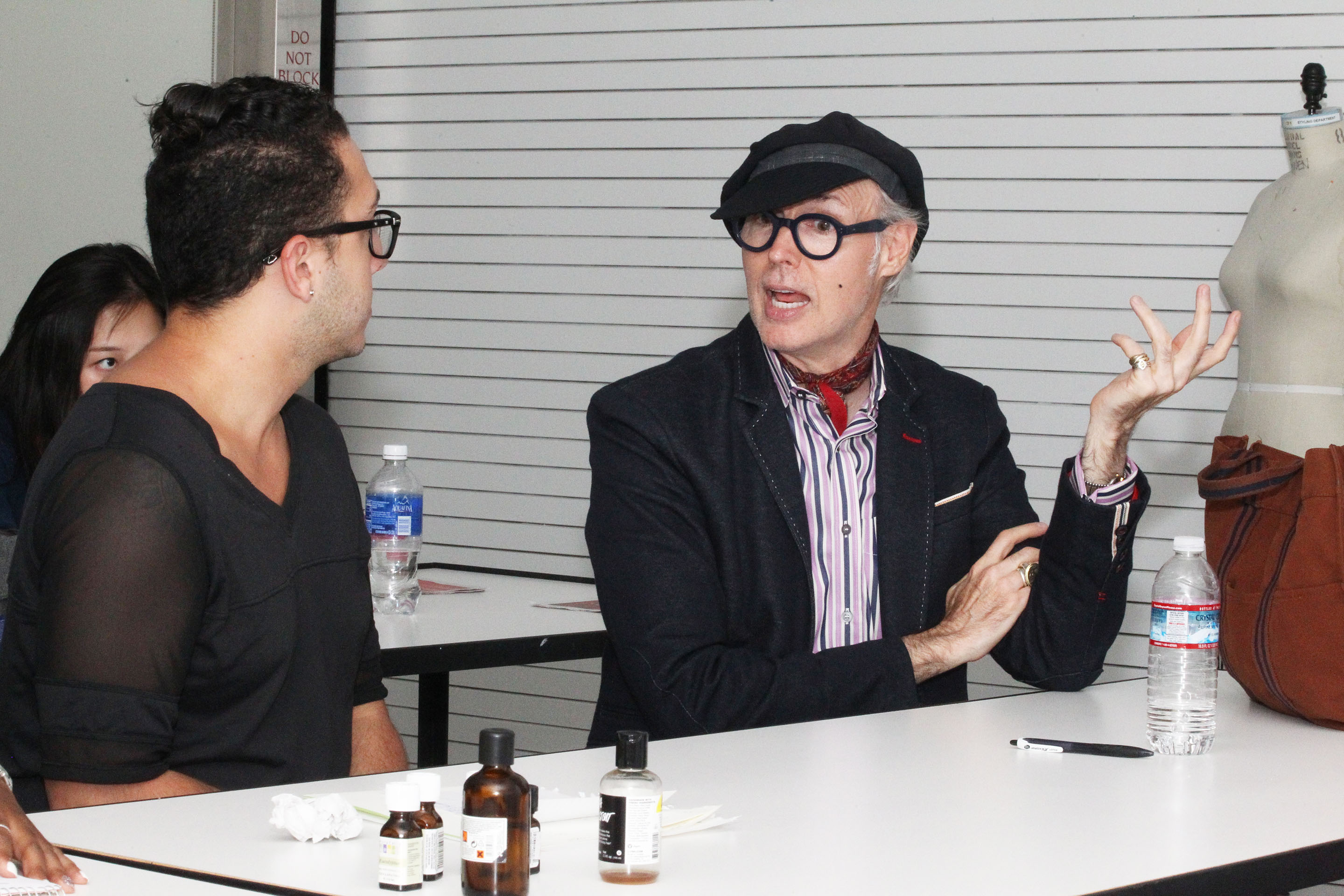 Dandy Patrick McDonald gives feedback to fashion merchandising students on their group project. Photo by Bob Toy.