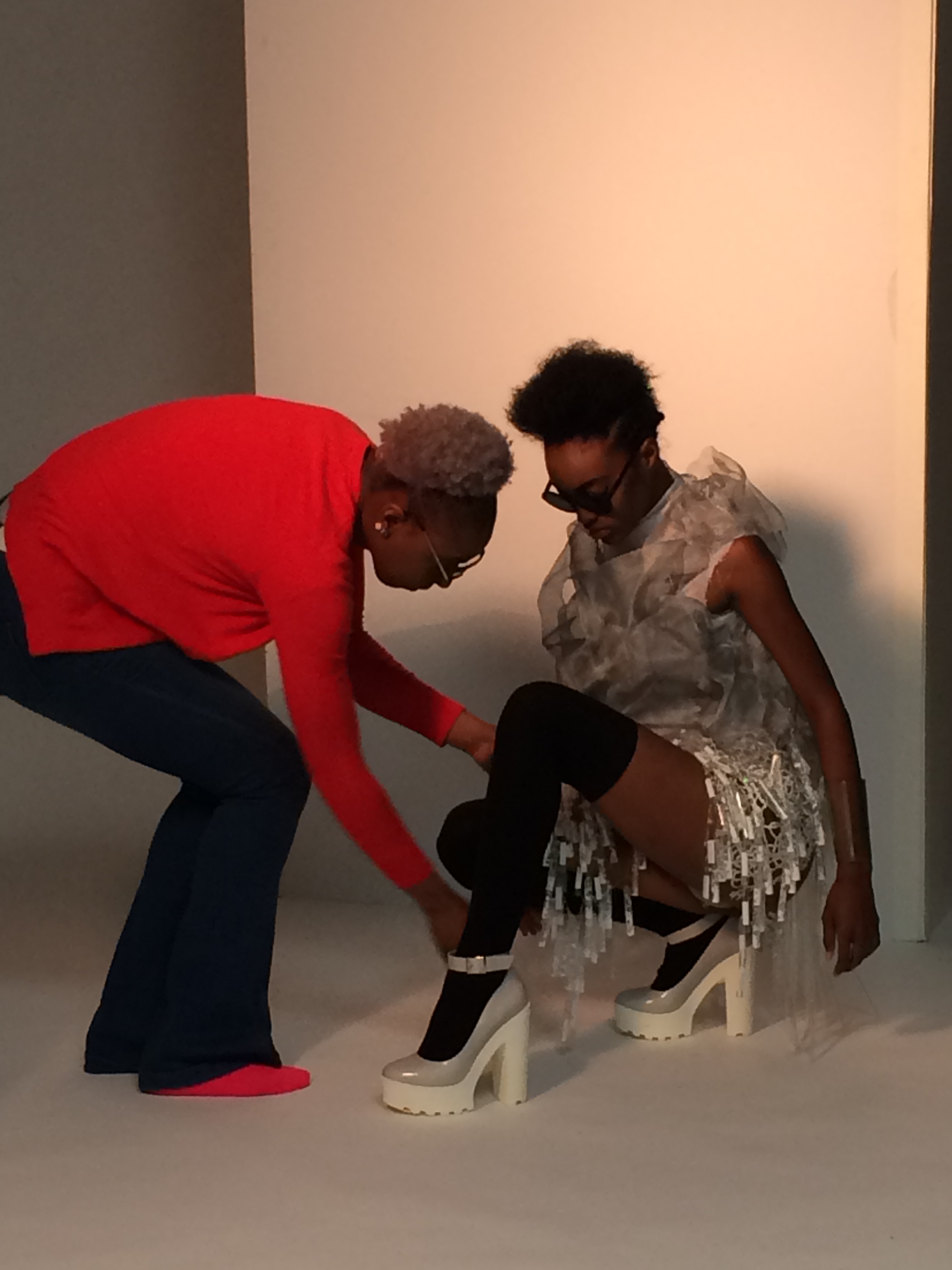 A student styling a model during the photo shoot. Photo courtesy of Bethany Meuleners.