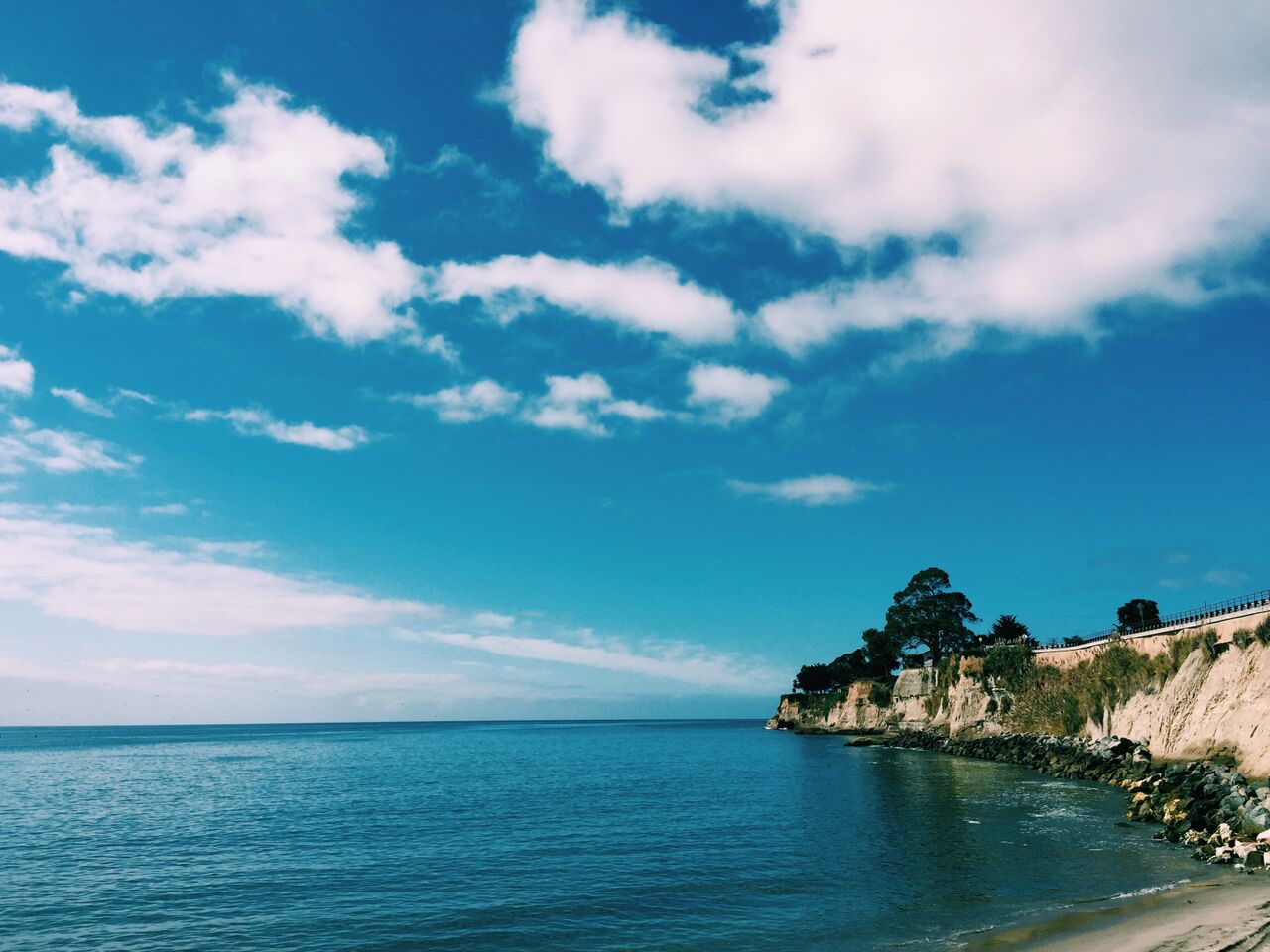 Peninsula in the sea with blue sky and clouds