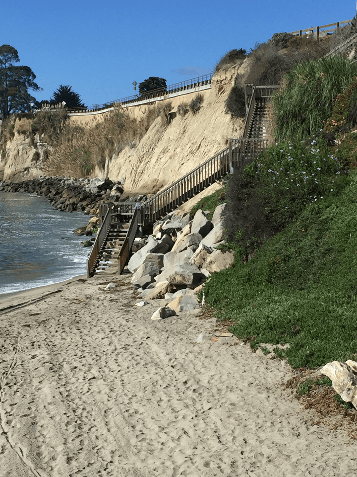 Wooden staircase ascending steep cliff on the beach