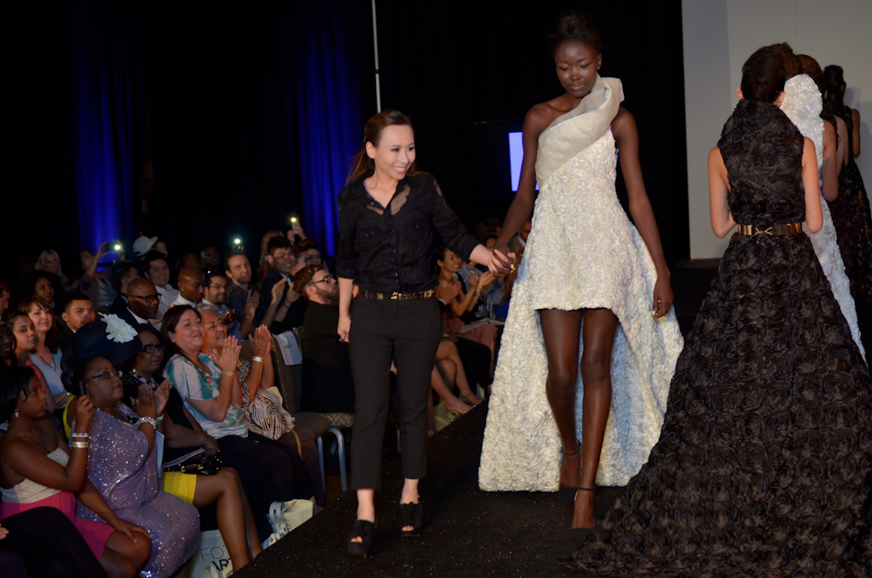Cindy Quach walking with her finale model to end the show. 