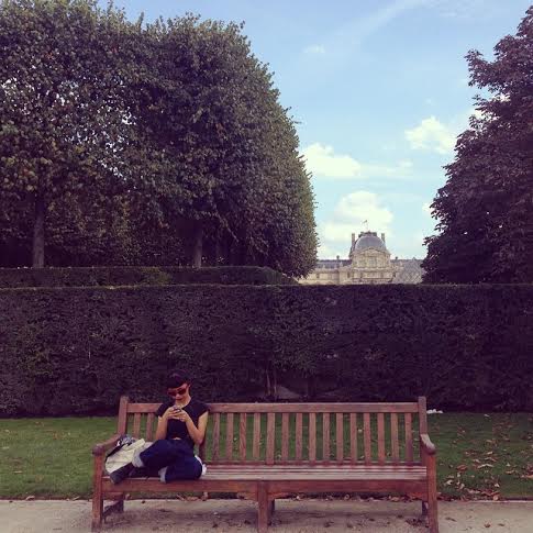 Yuko Okudaira relaxing on a bench in Paris.